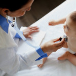 Doctor examining baby.
